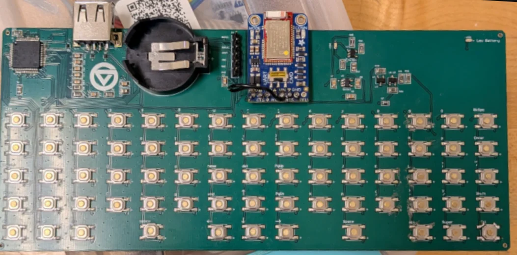 The assembled custom PCB with tactile switches and a Bluetooth module